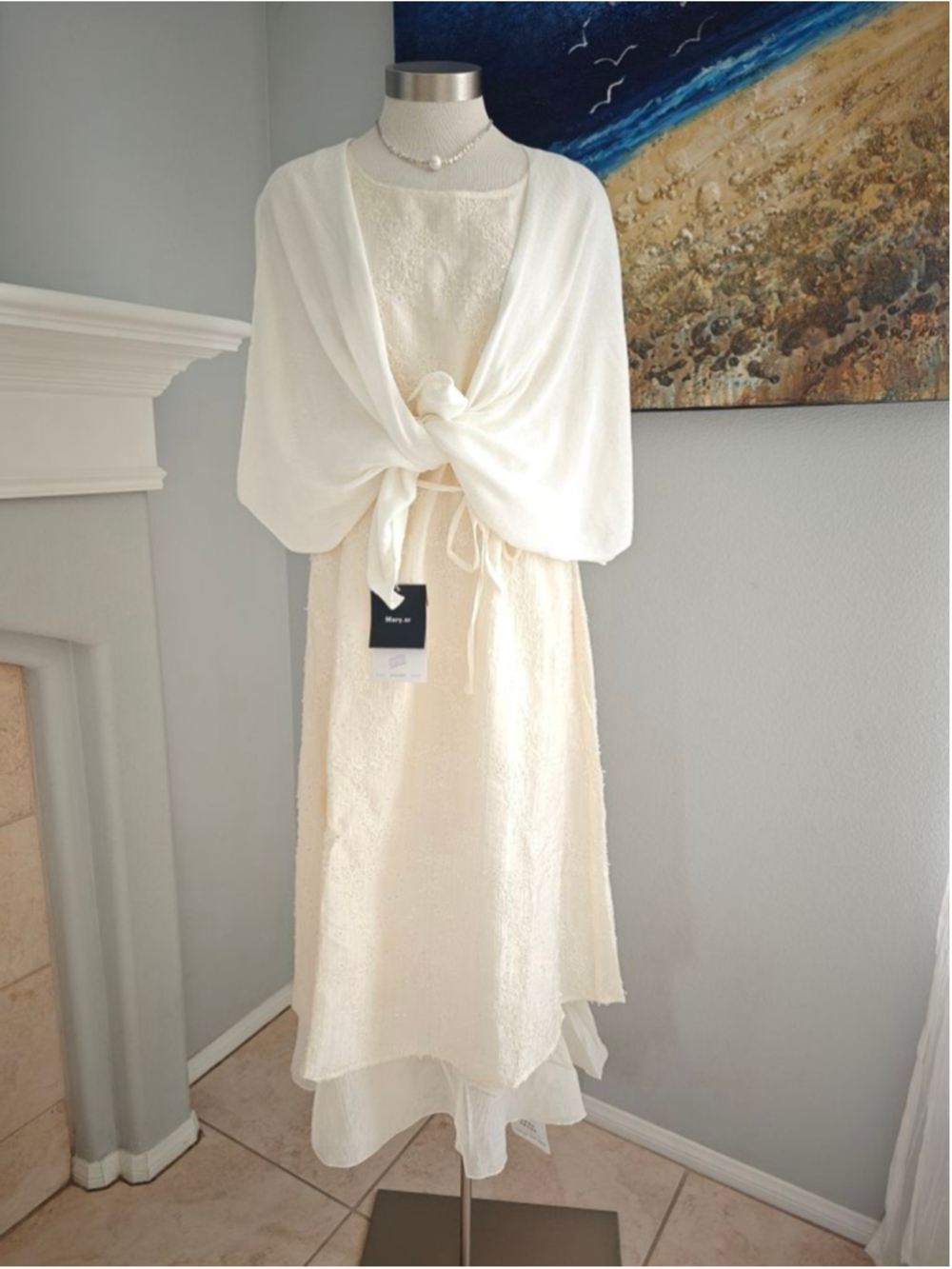 Elegant ivory maxi dress with delicate floral embroidery and subtle sequins thro